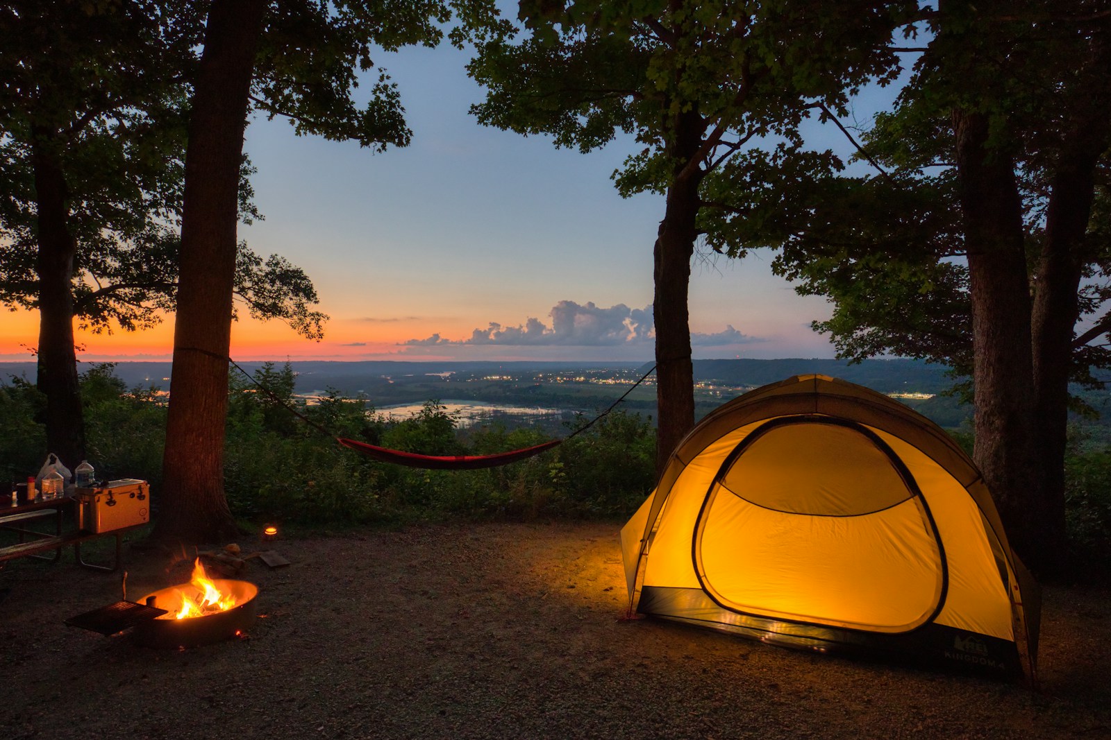 a tent set up in the woods at sunset for camping